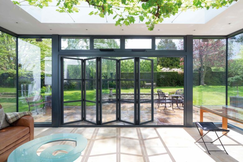 Precision-engineered bi-fold doors creating a seamless, light-filled connection between home and garden.